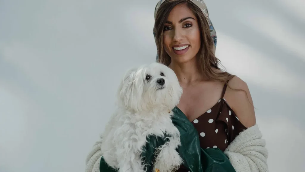 Woman holding a Maltese dog